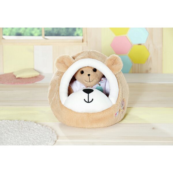 Ein mehrfarbiges Bett für die Baby Born-Puppe in Form eines Höhlenbären